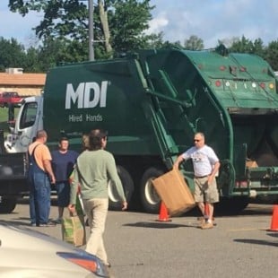 male workers with MDI recycling truck